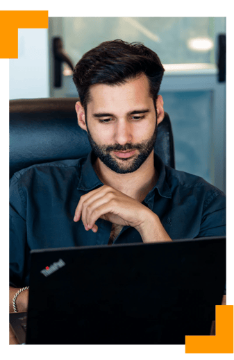 Cybersecurity account manager working on project proposal at the computer